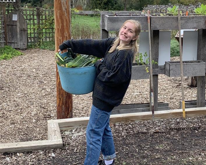 Girl holding a bucket of plants