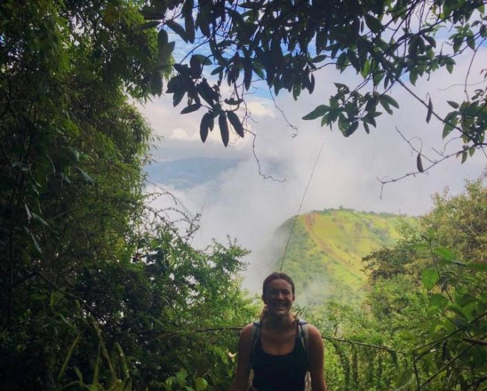 Woman hikes in the rainforest