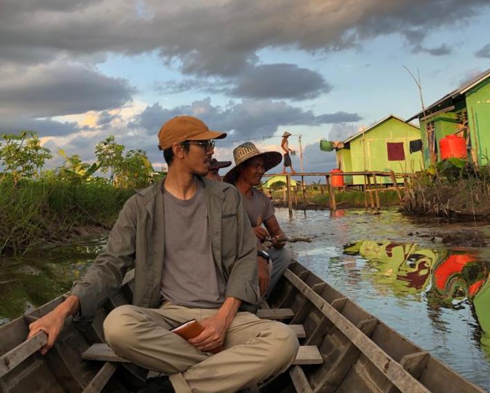 Man sits in canoe