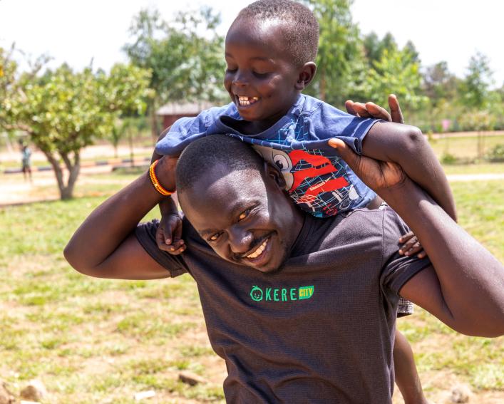 Man carries child on his back