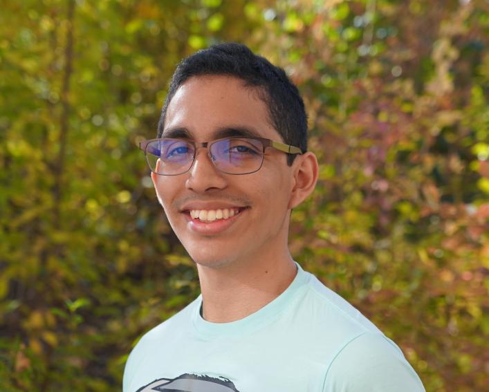 Photo of a man smiling at the camera.