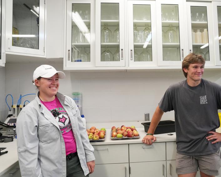 Two smiling people in a lab