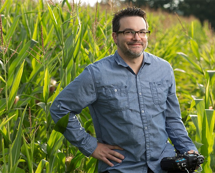 michael gore with controller in corn field