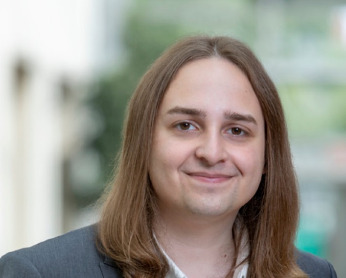 A photo of Noah Mapes with a blurred background.