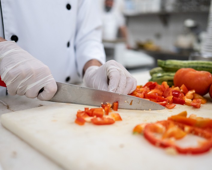 Chef prepares vegetables in a commercial kitchen