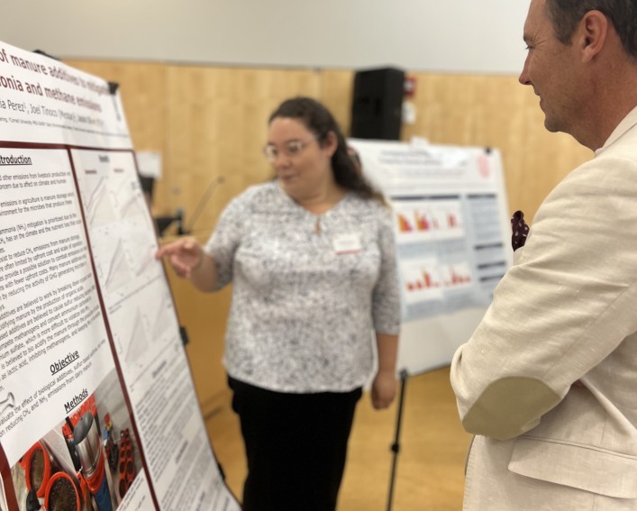 two people standing by a science poster