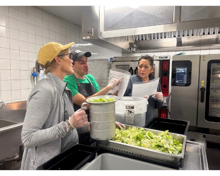 Cooks reading recipe in kitchen