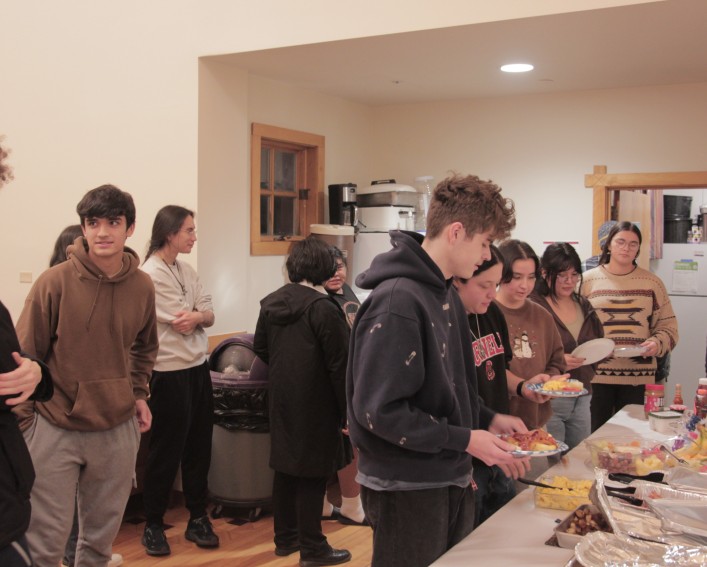 Students wait in line for a buffet.