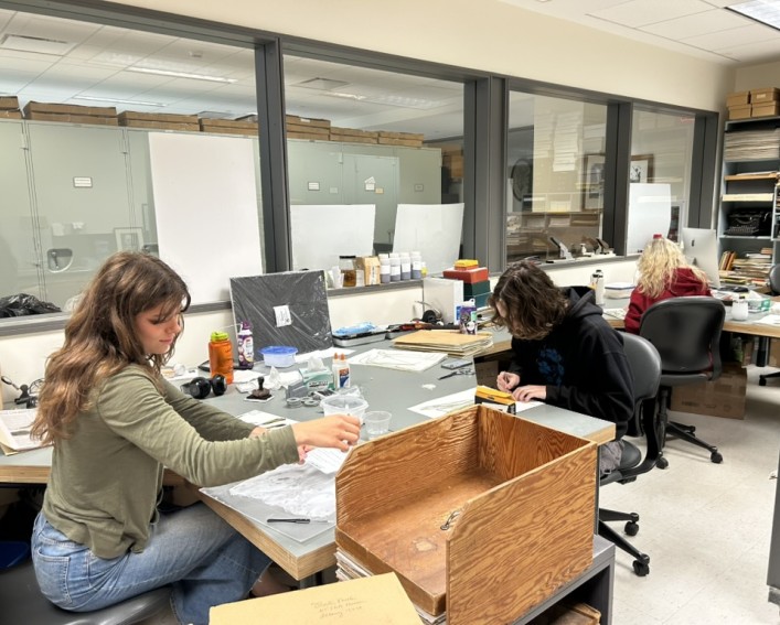3 students working at BH mounting herbarium voucher specimens