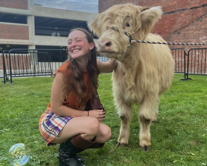 Bryn Terwilliger with a cow on campus