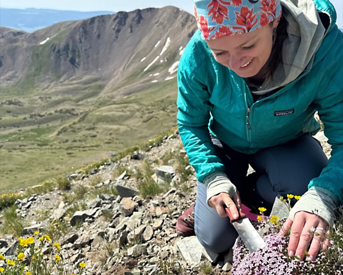 hannah marx with trowel above the treeline