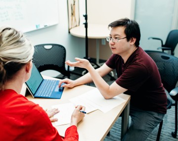 People talking at a desk