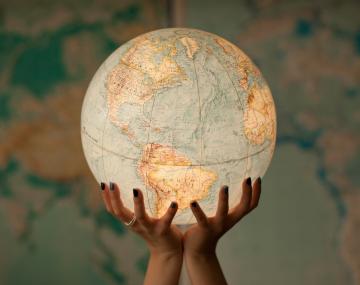 Hands holding a globe