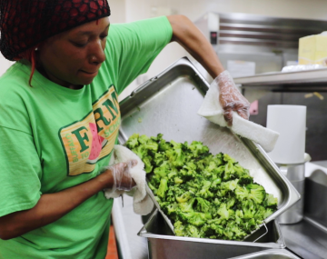 Selema Harris, a food service employee at City Honors School in Buffalo, New York, prepares locally-grown broccoli for the school’s lunch.