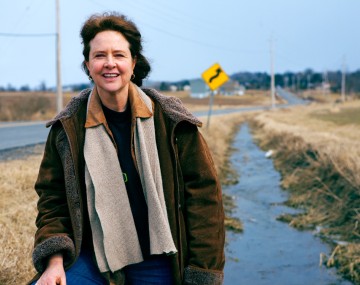 Woman on roadside with overcoat