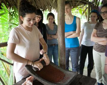 people grinding plant material
