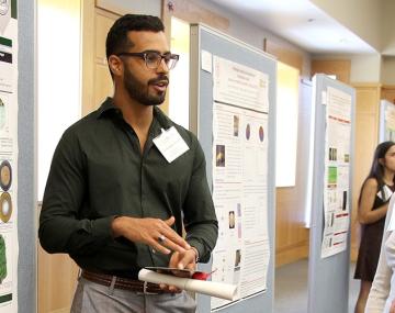 two people beside a poster