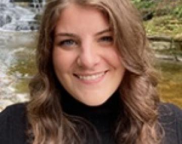 Headshot of a woman in front of a waterfall