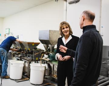 Cathy Young talking with a man inside a food incubator. 