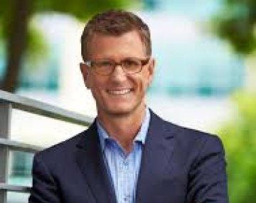 Man smiling with his arms crossed