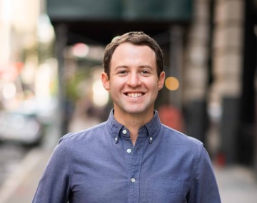 Man smiling on city street