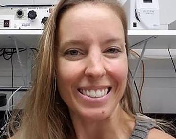portrait of a woman in front of white electronic equipment