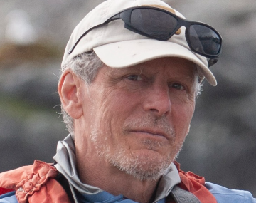 a man with a white hat with sunglasses on them