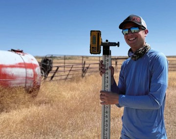 Person standing in a field with instruments