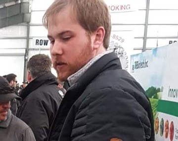 Photo of a person with light hair and a black jacket