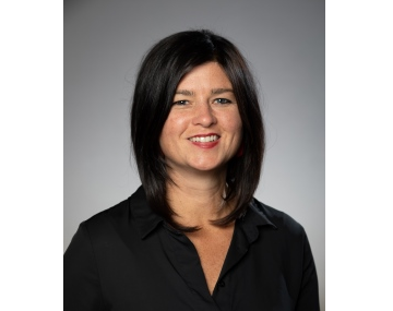 An image of Sarah Evanega, a woman smiling