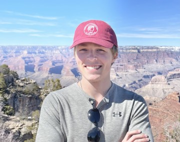 Guy standing in front of mountains