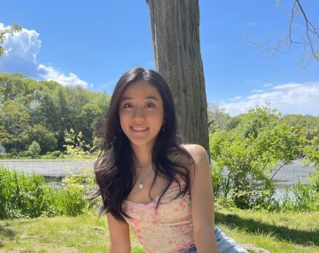 Girl sitting on a blanket on the grass