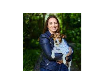 An image of a woman holding a dog