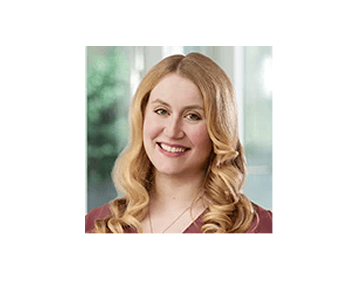An image of Alyssa Pugh, a long-haired woman smiling.