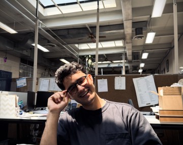 Student sits in computer chair in research space