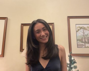 Maylani smiles at the camera.