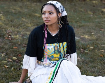 Shantel sits in a field of grass.