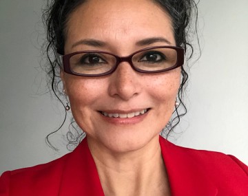 Portrait of a person wearing a red jacket and glasses.