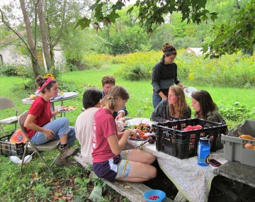 Dilmun students at a picnic table with produce