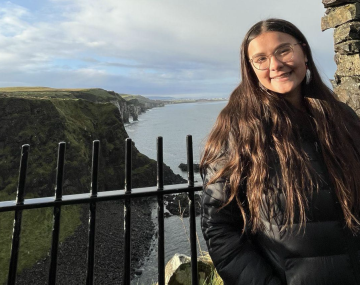 MJ stands in front of ocean views.