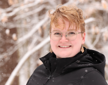 Sarah Lavoy-Brunette stands smiling outside on a snowy day.