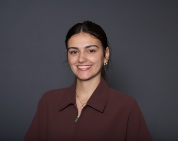 Woman in suit jacket with gray background