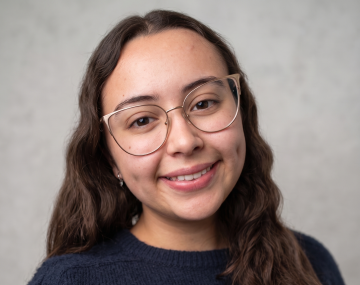 Woman with glasses and blue sweater