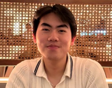 Man in white polo shirt sitting