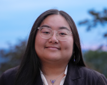 Smiling woman with glasses in suit jacket