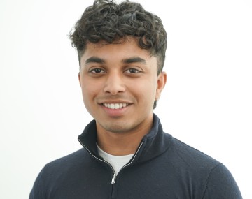 Man wearing dark sweater with collar popped up