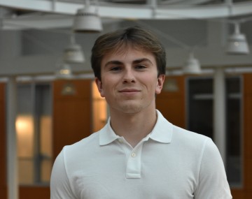 Standing man in white polo