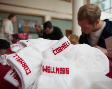 close up of white socks with a person writing behind them