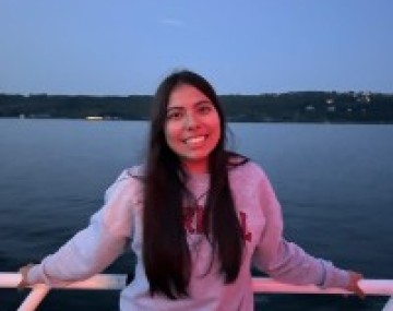 Shania stands on a dock in front of a lake