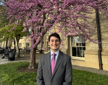 Person standing in front of a tree